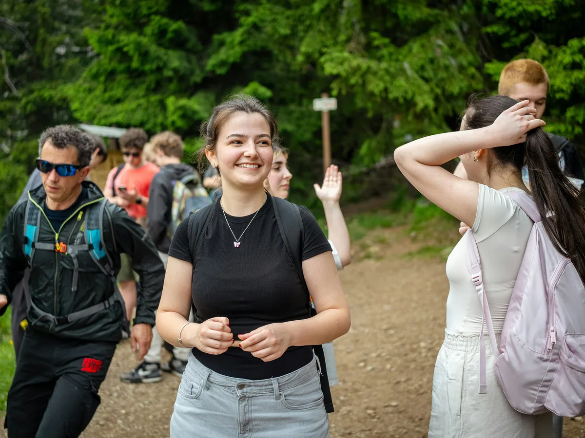 A group pausing together during a woodland walk